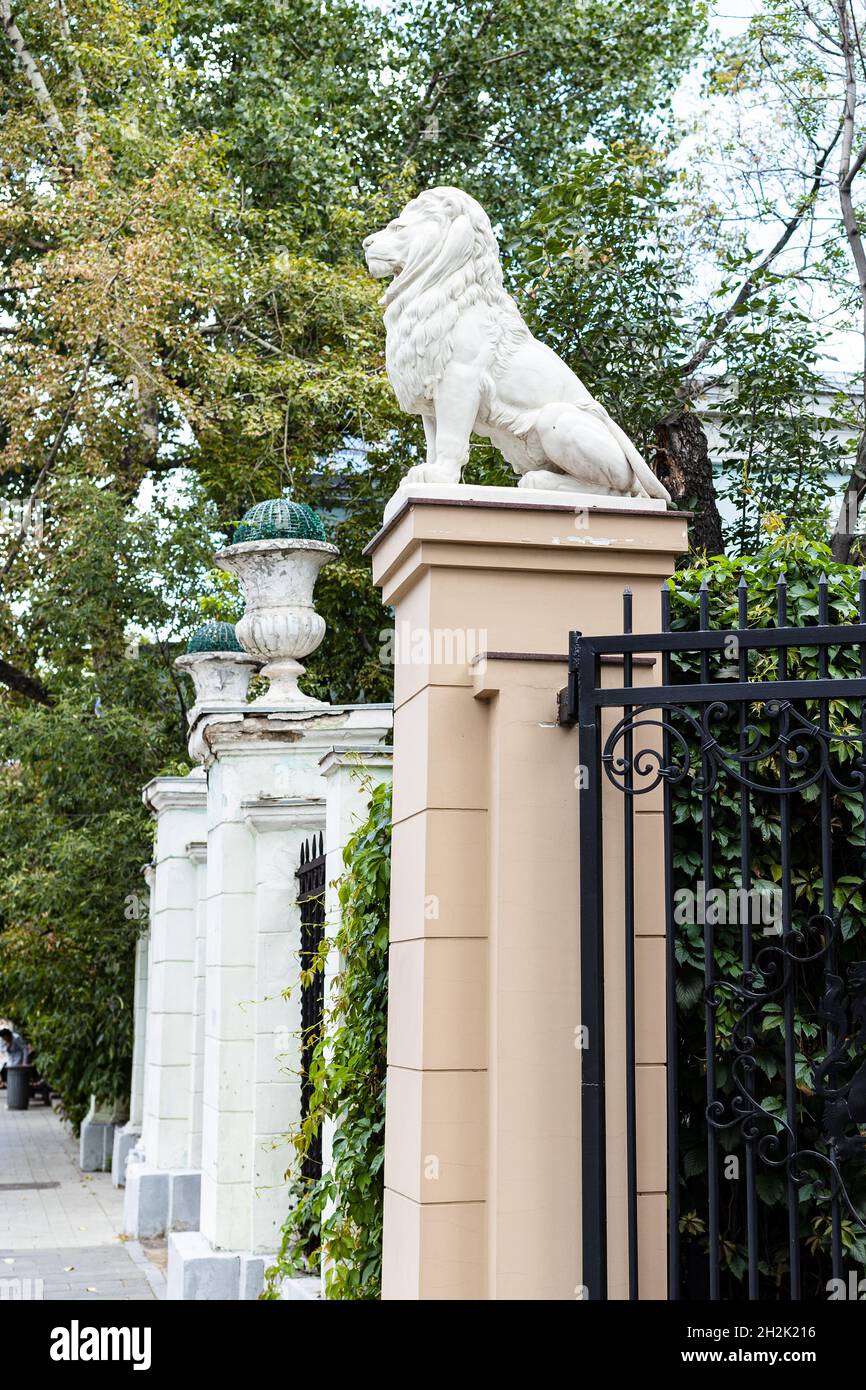 lion sculpture on gate of urban yard on Malaya Dmitrovka street in