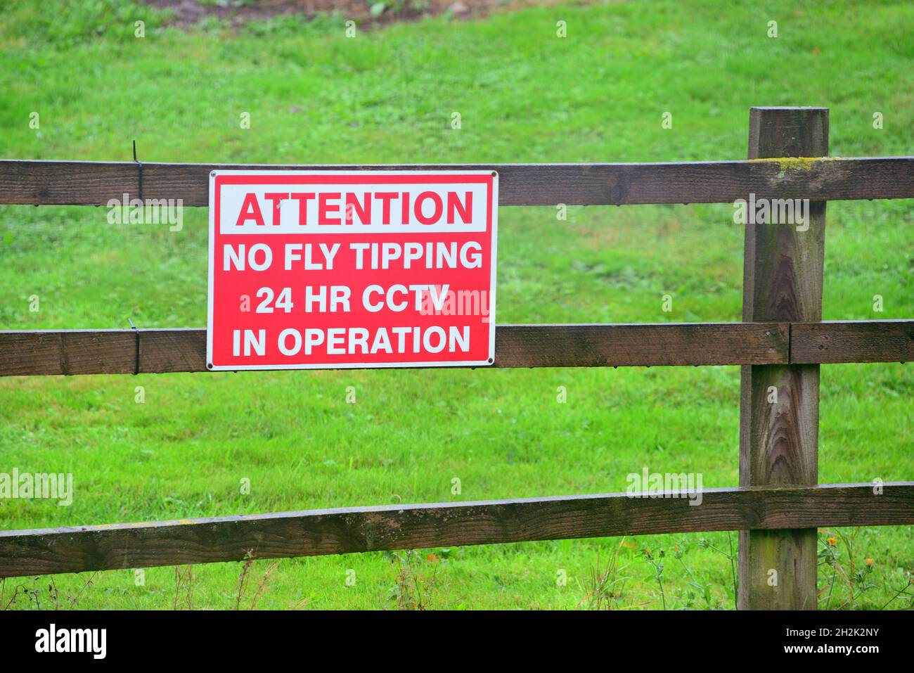 warning no fly tipping 24 hour cctv in operation sign united kingdom Stock Photo