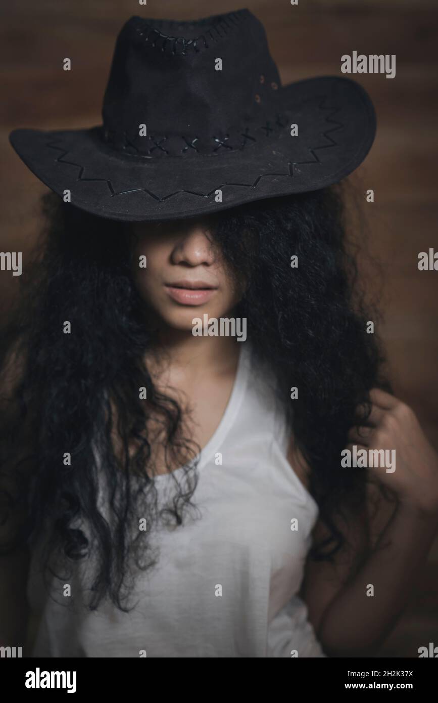 Curly hair girl in cowboy hat Stock Photo Alamy