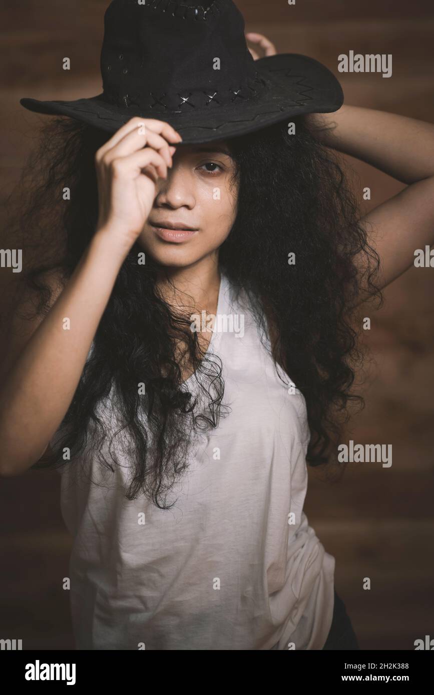 Curly hair girl in cowboy hat Stock Photo Alamy