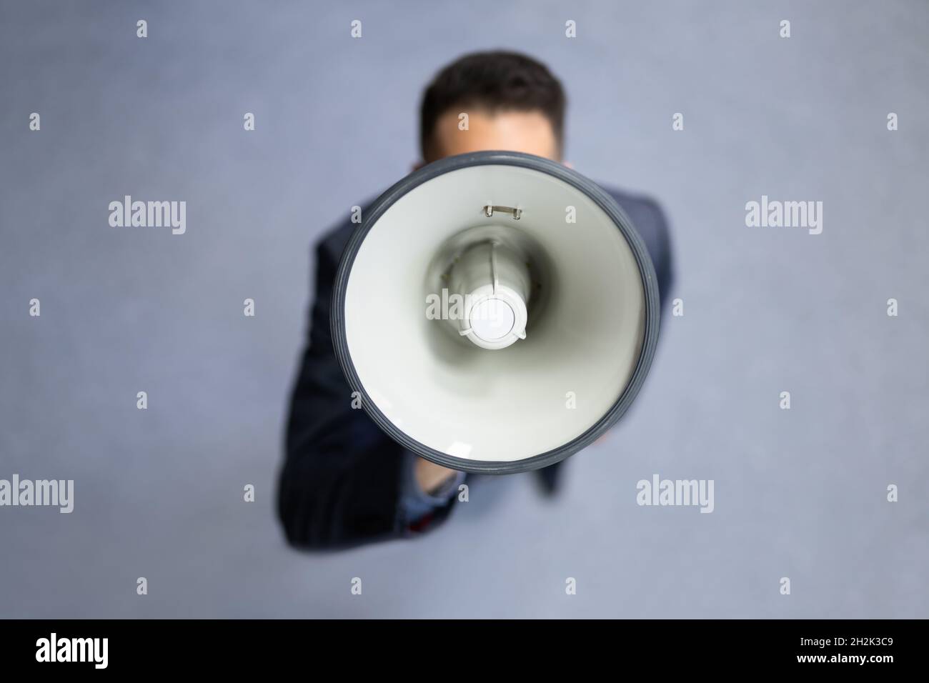 Megaphone Attention Concept. Man Shouting Using Loudspeaker Stock Photo