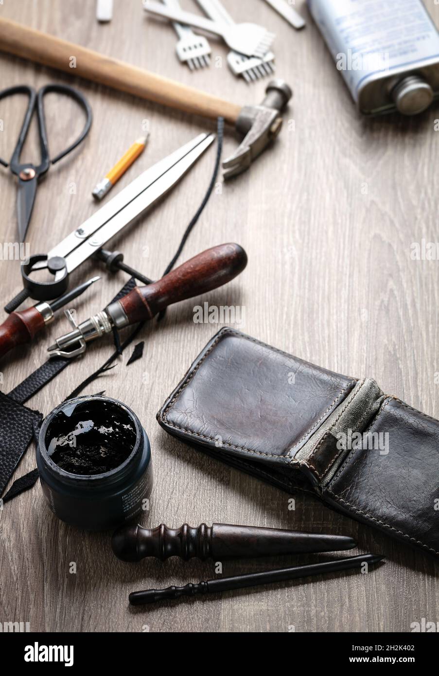 Concept of leather handcraft instruments. Colouring genuine leather Stock Photo