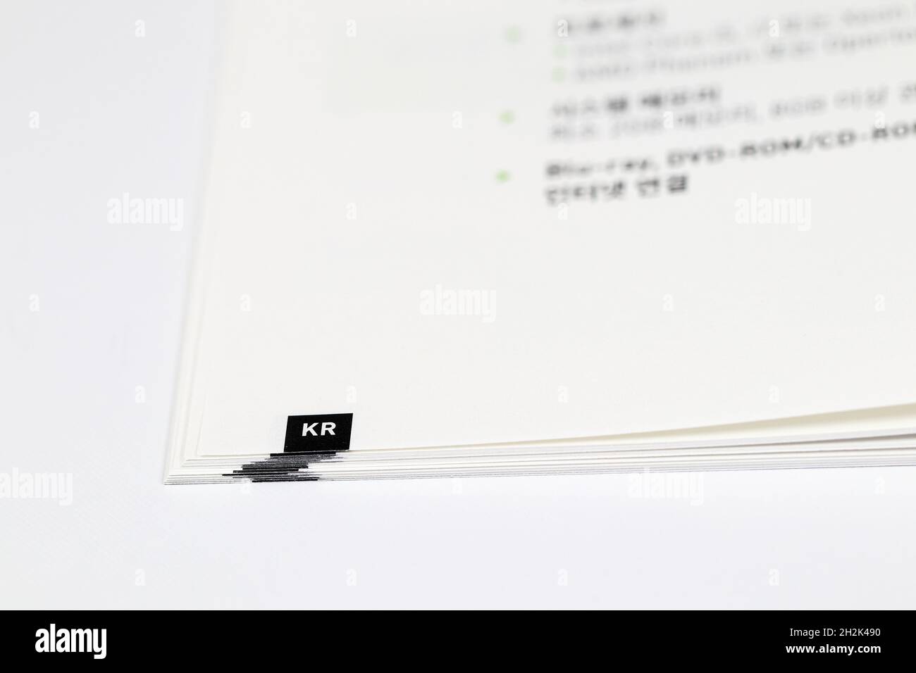 Close-up Of language index on multilingual book or user manual with open pages. KR mean korea Language Book. Stock Photo