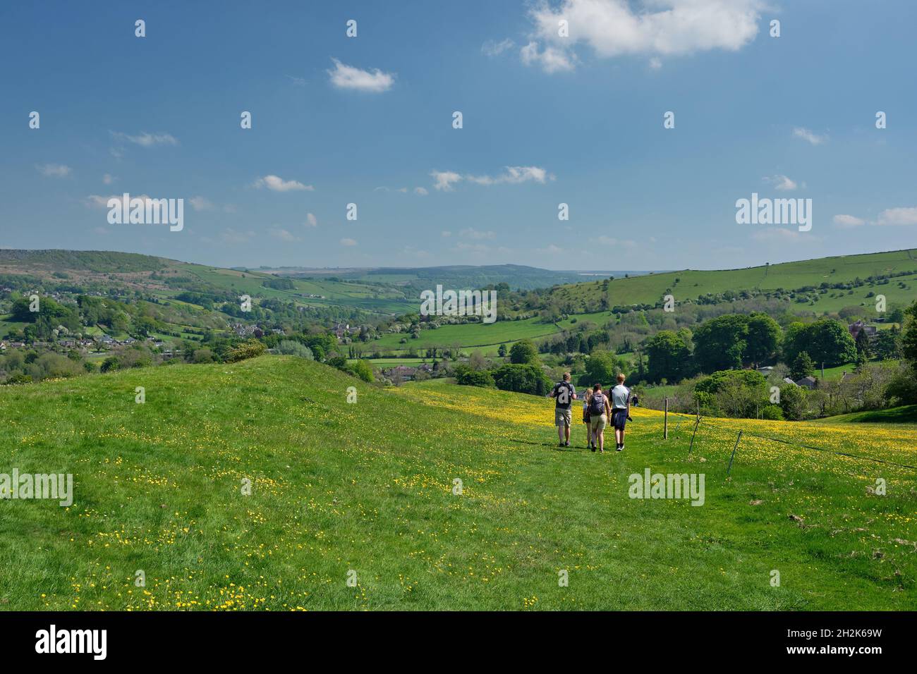 Walkers descendng grassy path from Eyam to Stoney Middleton, Hope Valley, Peak District, UK Stock Photo