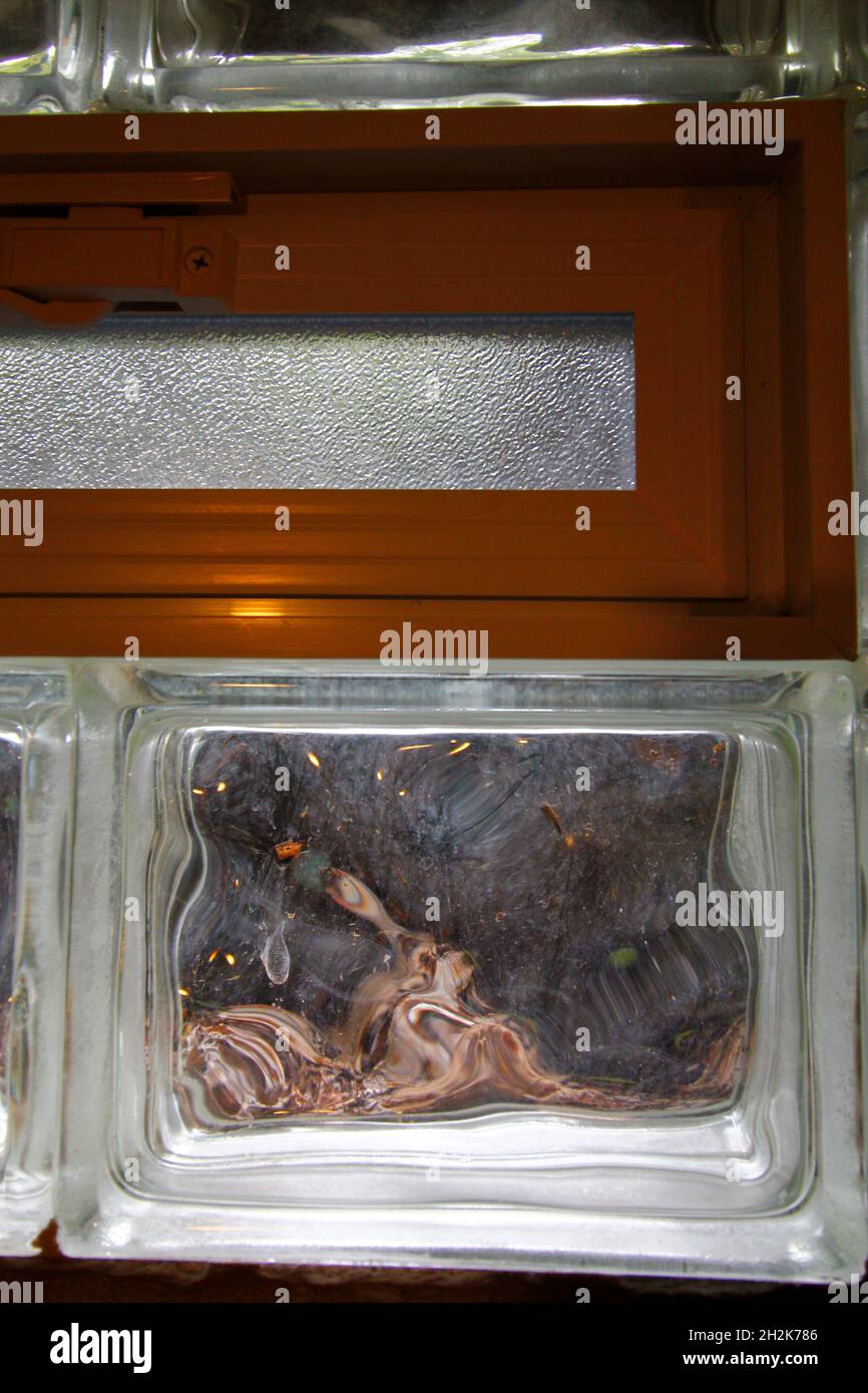 Glass block window with air vent in a basement Stock Photo Alamy