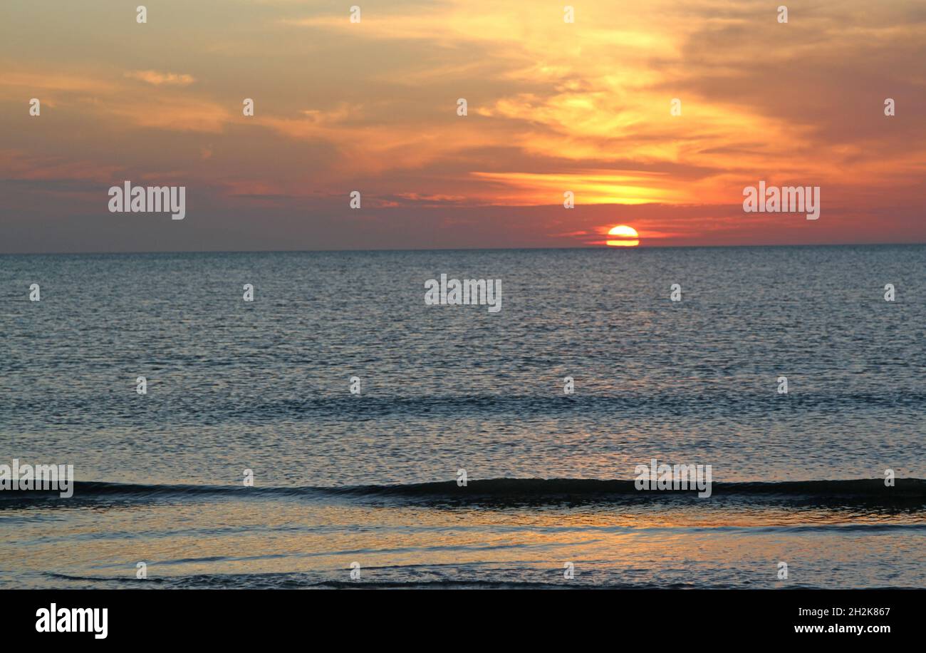 Sun and cloud at sunset with beautiful colors from the beach Stock ...