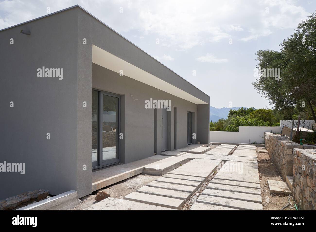 Construction site of a modern house with a flat roof on a mountainside Stock Photo