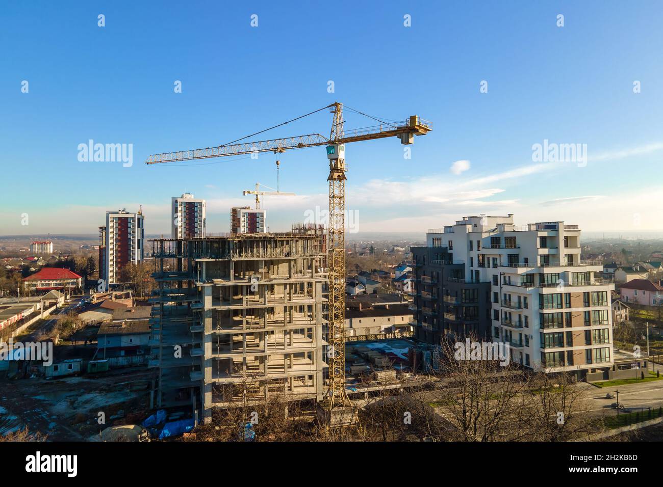Aerial view of high tower crane and residential apartment buildings ...
