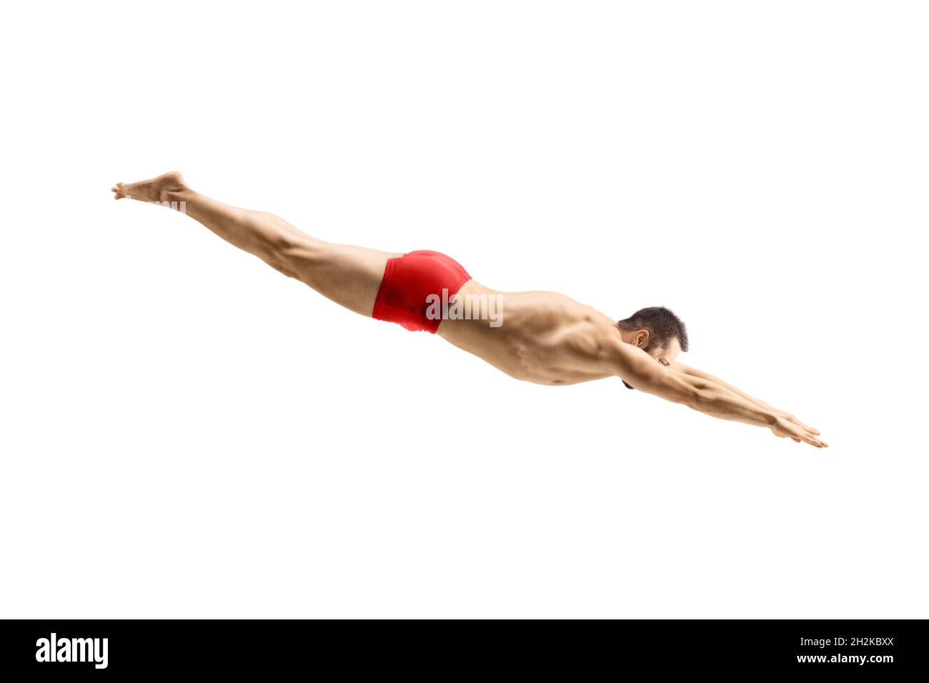 Male swimmer in a red swimsuit jumping to dive isolated on white background Stock Photo