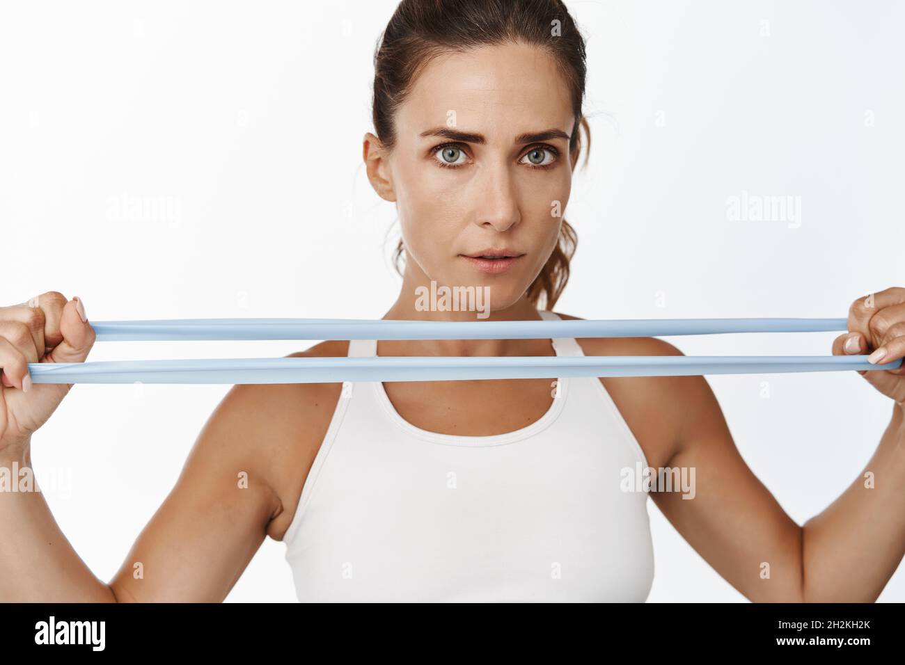 Close up portrait of strong female athlete, sportswoman stretch
