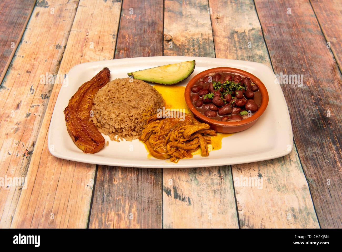 Colombian dish of coastal tray with red bean stew, shredded chicken