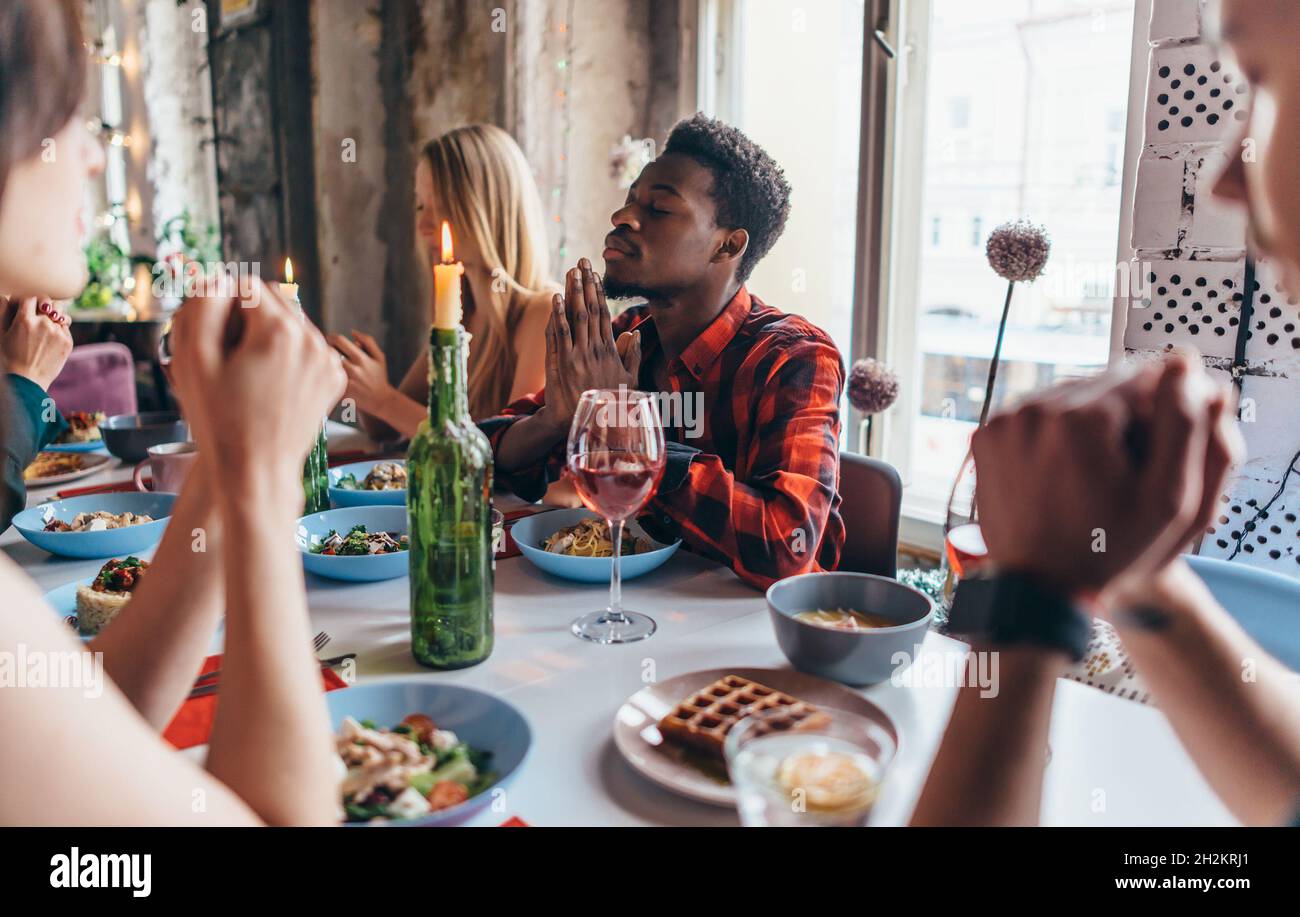 friends-saying-prayer-before-eating-meal-together-stock-photo-alamy