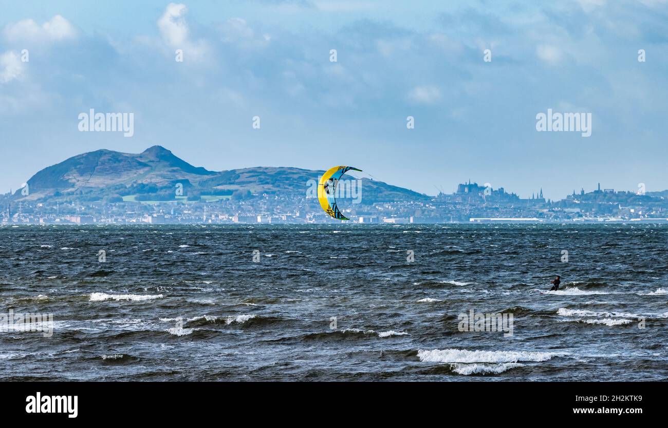 A windy day for kitesurfers in blustery weather on a sunny day in Firth of Forth with view of Edinburgh, Longniddry Bents. East Lothian, Scotland, UK Stock Photo