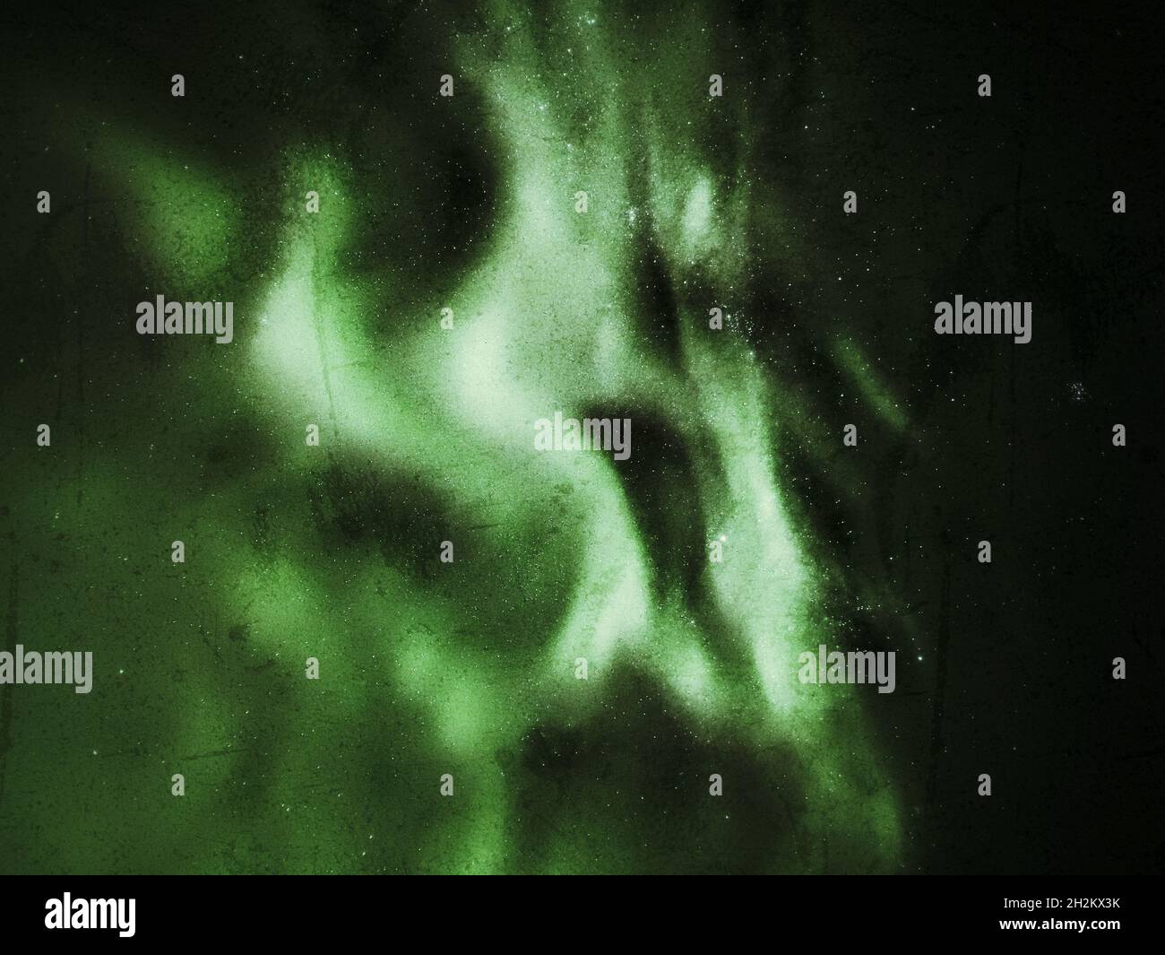 Grungy upward shot of northern lights on starry sky. Stock Photo