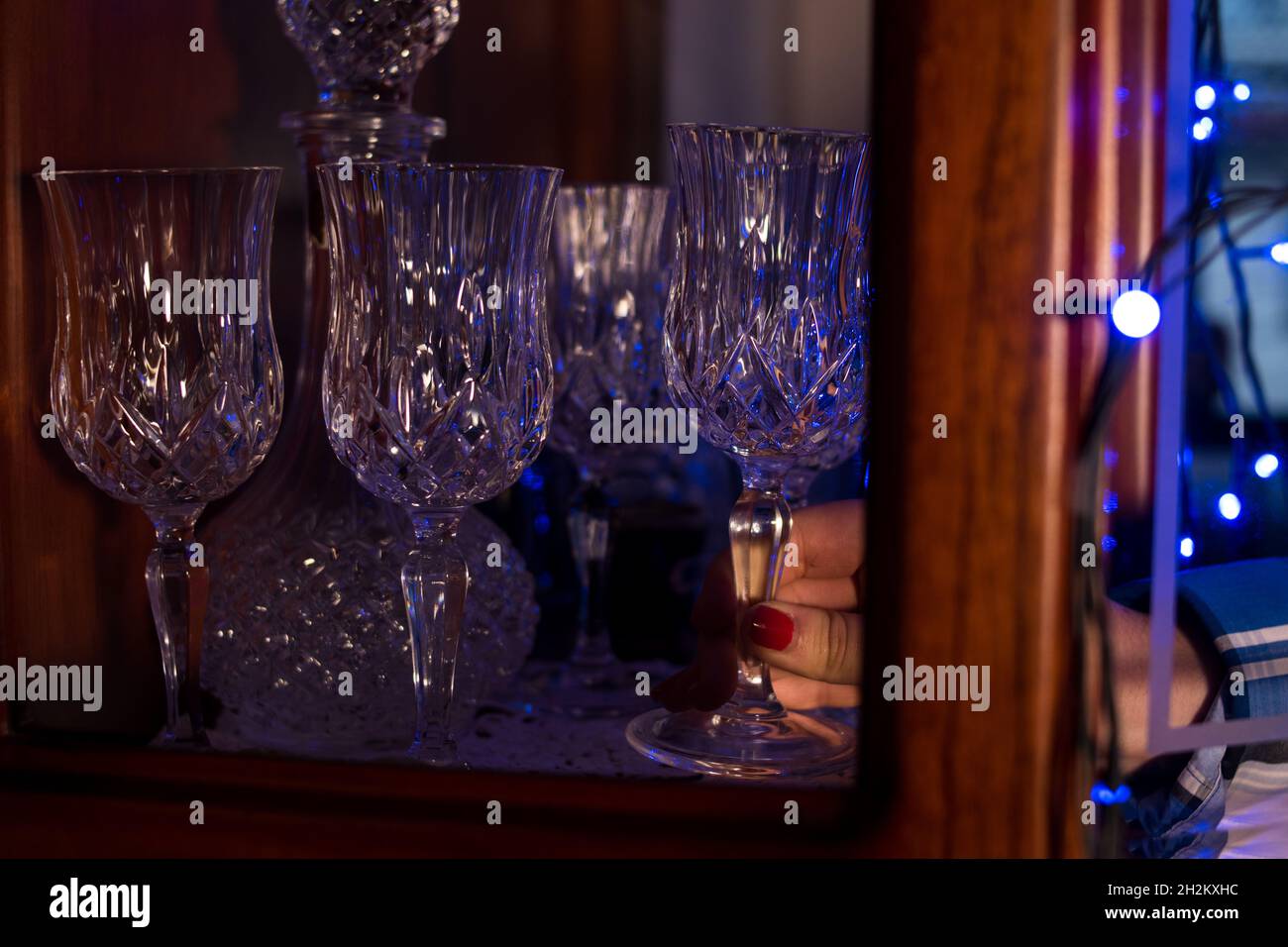 Barwoman taking some several glasses of champagne in a bar Stock Photo