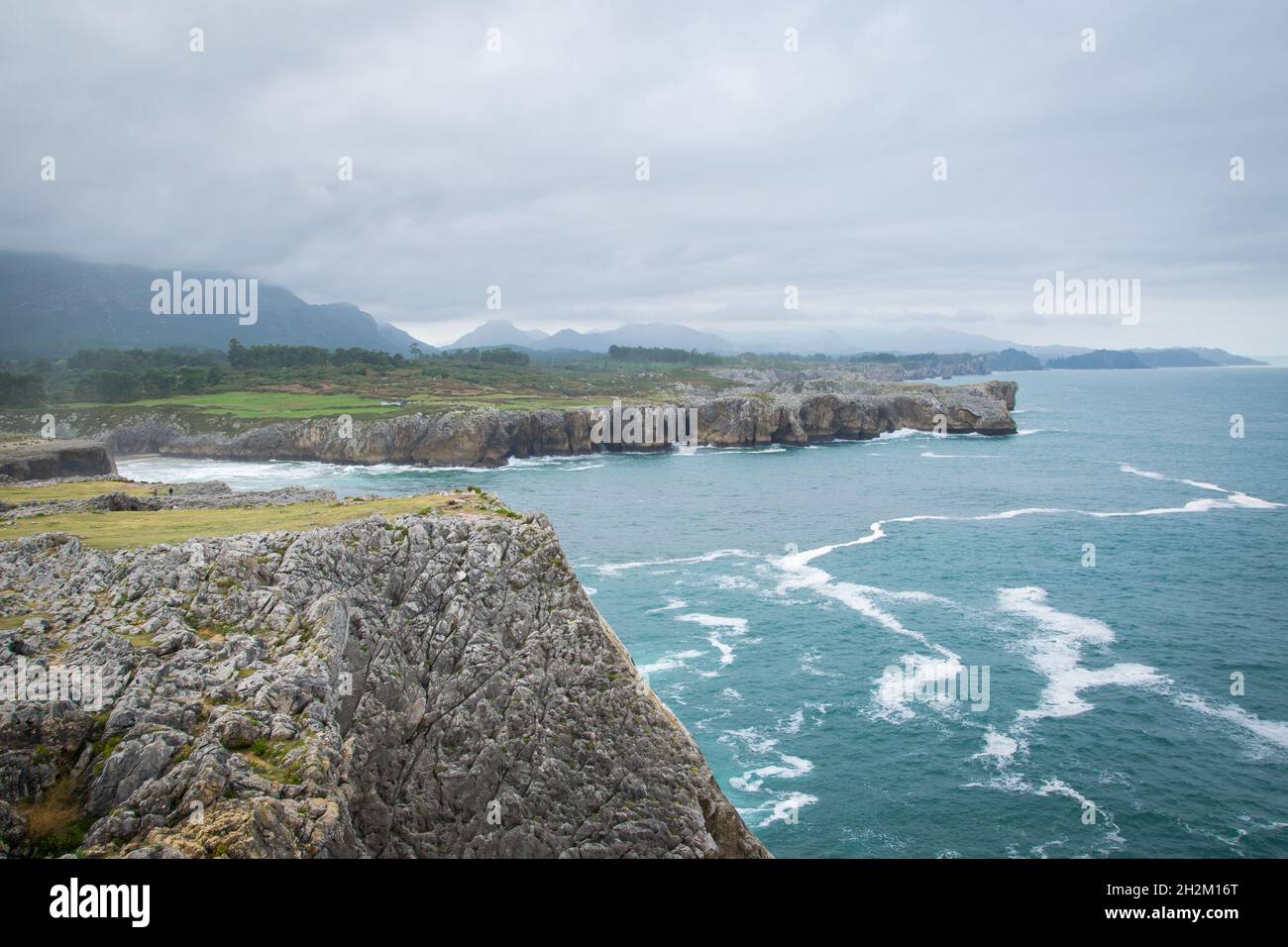 Dramatic cliffs at the Cantabrian coast in famous Bufones de Pria on a misty autumn day. Moody coastal landscape in Asturias, Northern Spain. Stock Photo