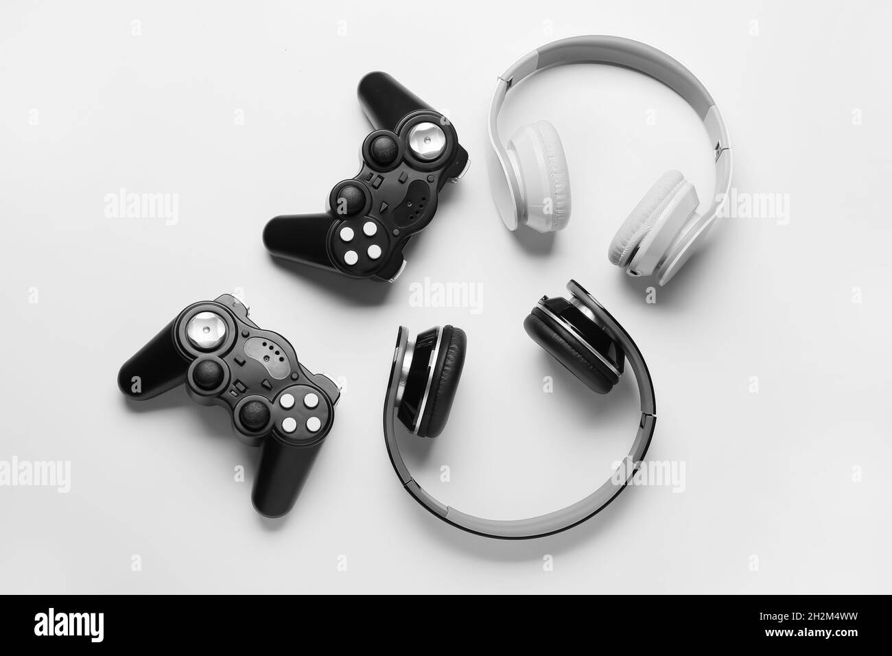 Modern joysticks and headphones on white background Stock Photo - Alamy