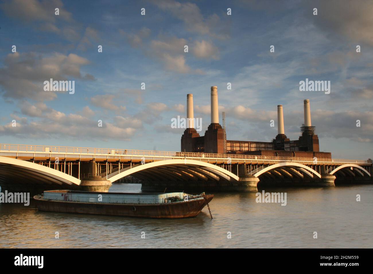 River Thames with barge Grosvenor Rail Bridge and Battersea Power Station Stock Photo