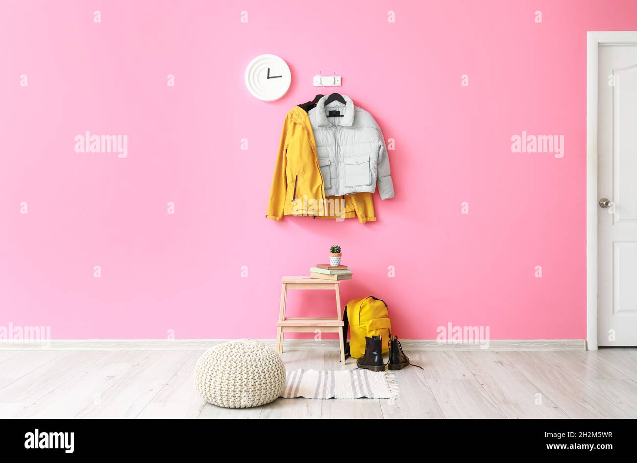 Interior of hallway with stylish jackets and pink wall Stock Photo