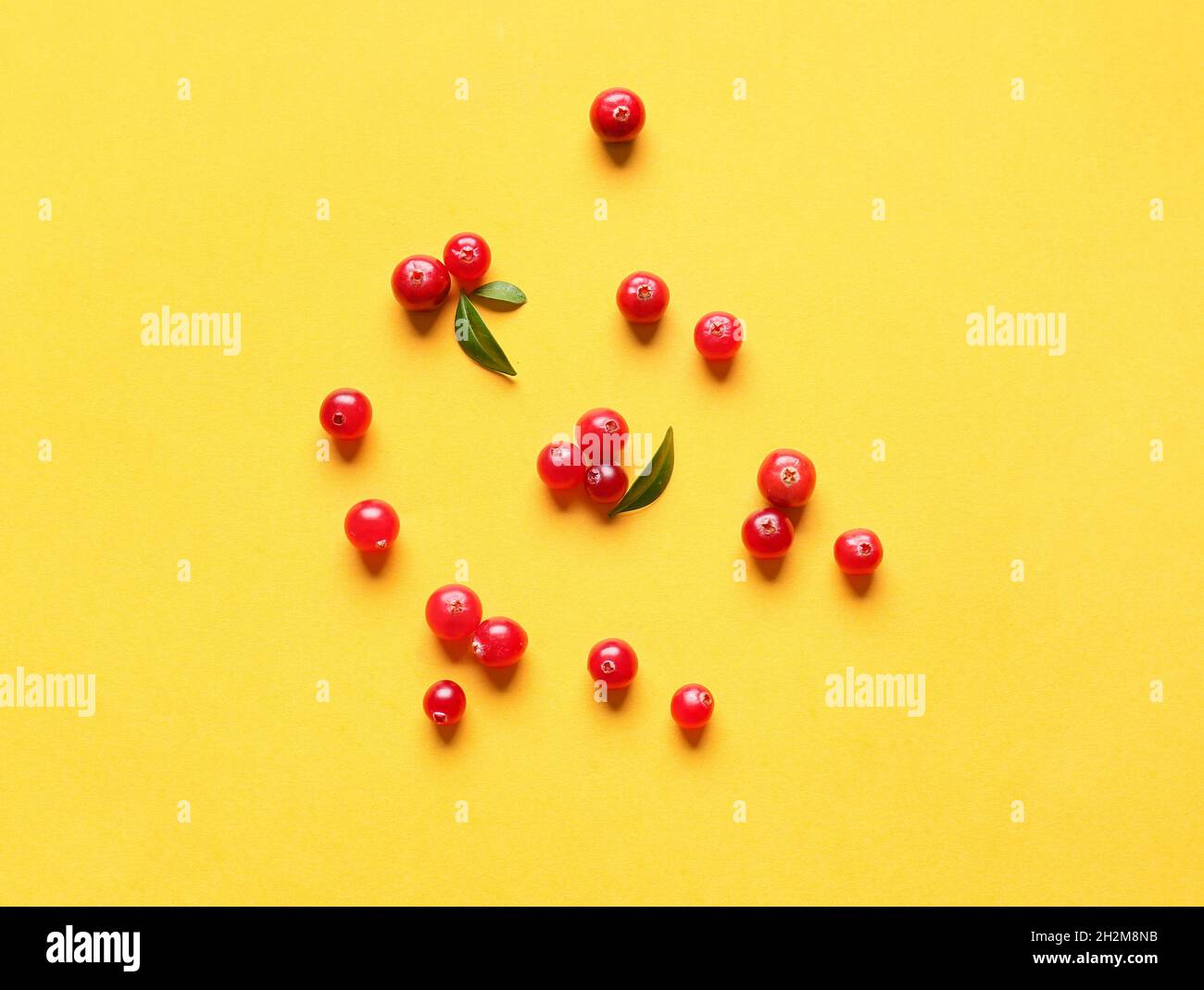 Fresh lingonberry on yellow background Stock Photo