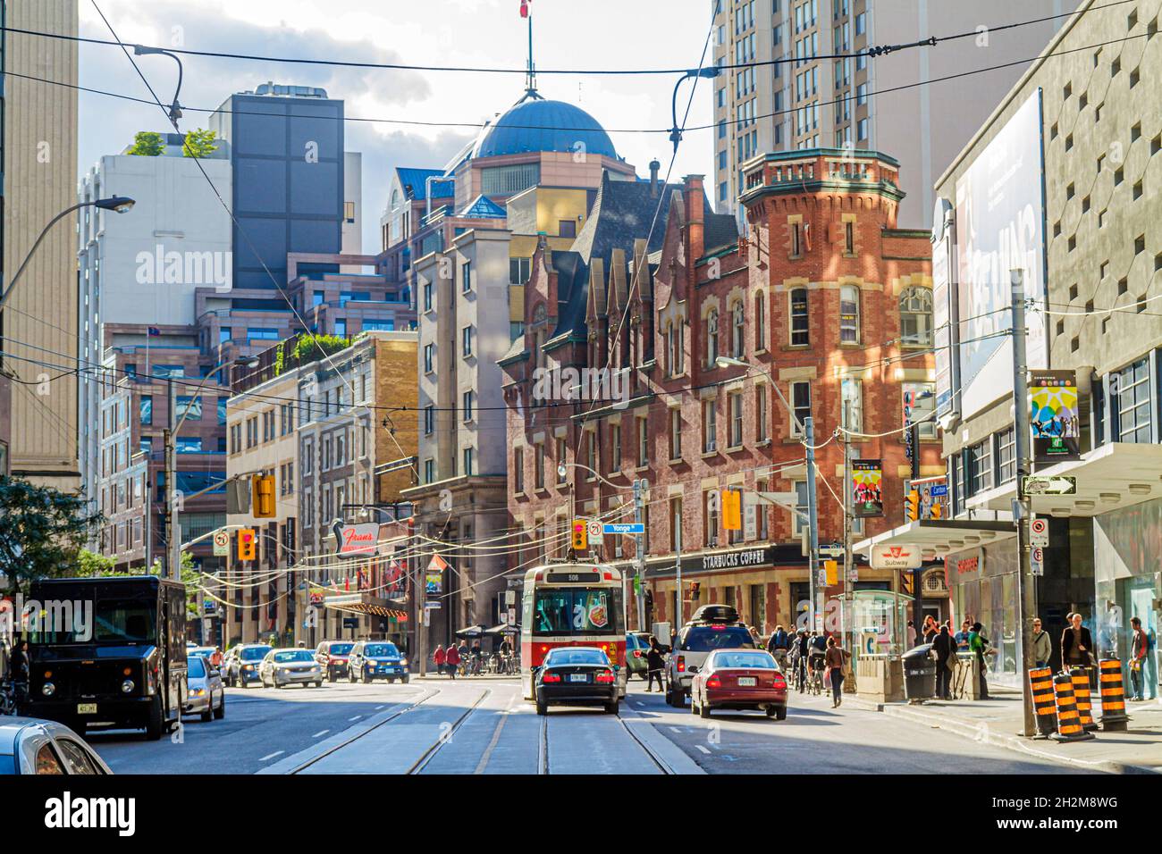 Toronto Canada,Carlton Street College Street Yonge Street,electric streetcar power wires traffic urban city skyline buildings Stock Photo