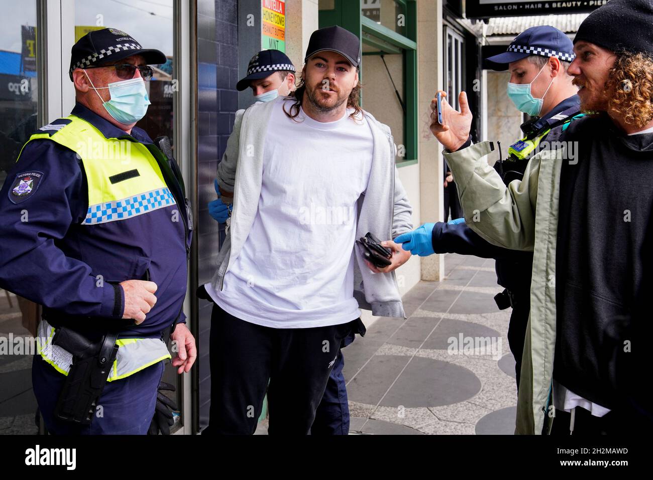 Police officers handcuff a man at a Victorian Freedom Movement protest on  the second day of eased coronavirus disease (COVID-19) regulations,  following a lockdown to curb an outbreak, in Melbourne, Australia, October