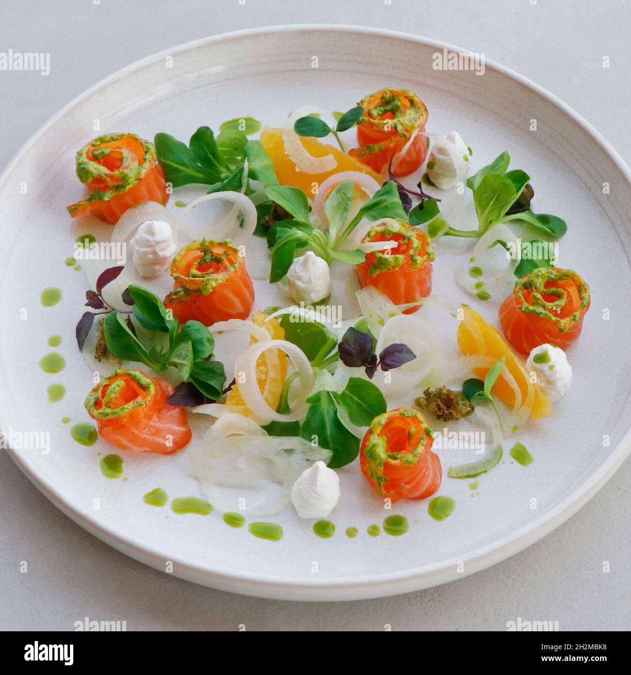 salmon gravlax, salt and sugar cured fresh salmon in a serving plate with  leaves and garnish, fine dining Stock Photo - Alamy