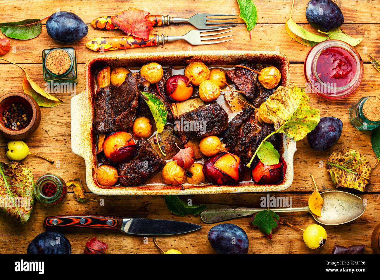 Beef ribs grilled in plums and pears.Meat ribs fried in fruit sauce