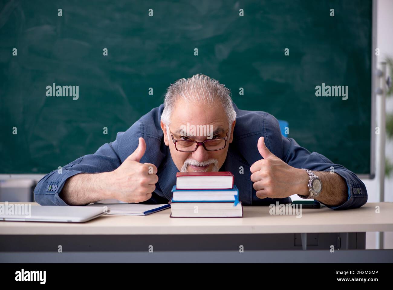Old teacher in the classroom Stock Photo