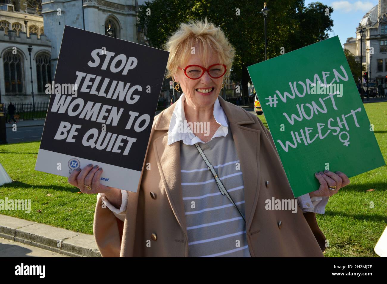 A protester holds placards during a rally at Parliament Square. LGB community is calling on the public bodies and private companies who are members of Stonewall to come out of the charity scheme. Stock Photo