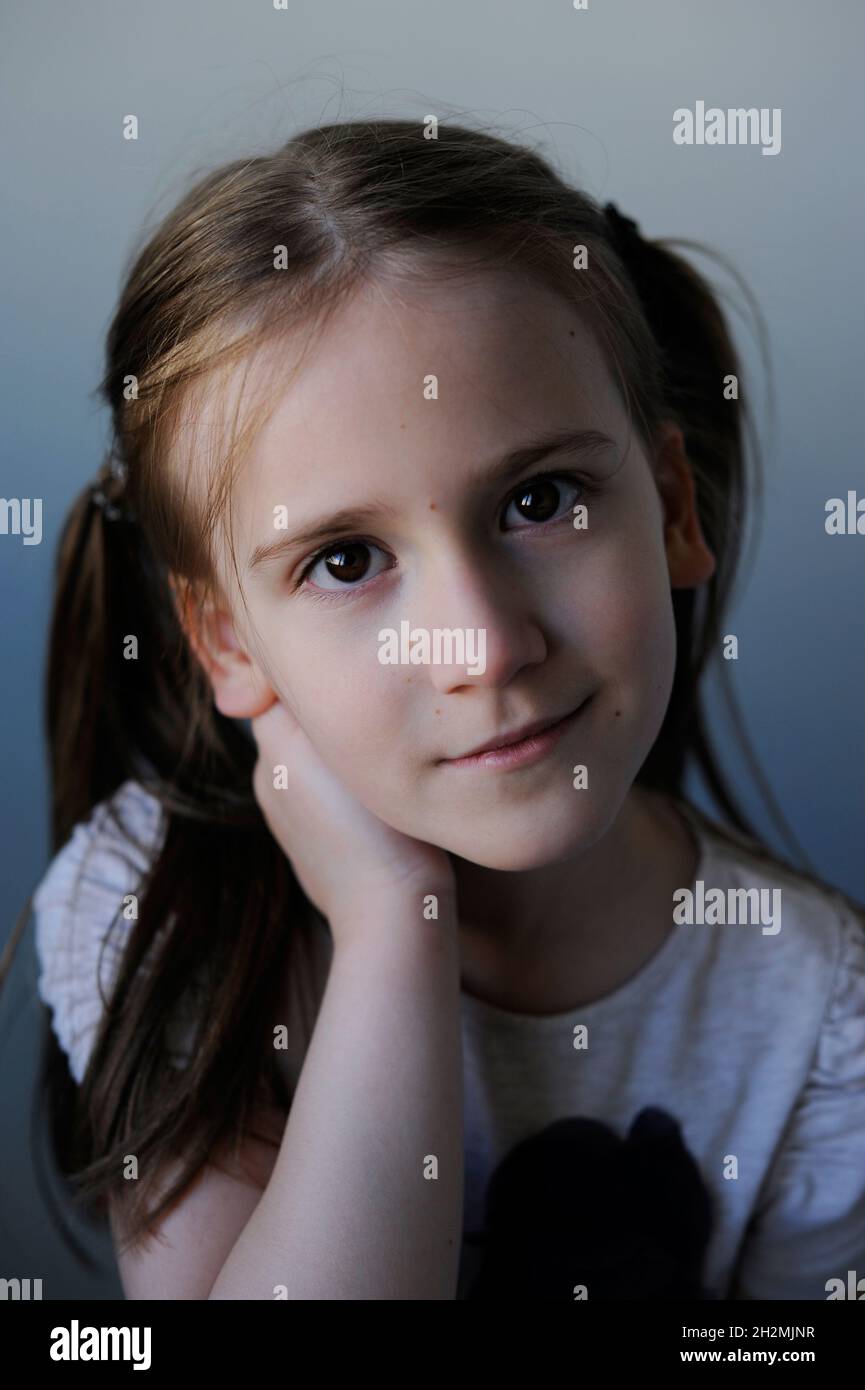 Close up portrait of adorable young firl. Looking at camera. Stock Photo