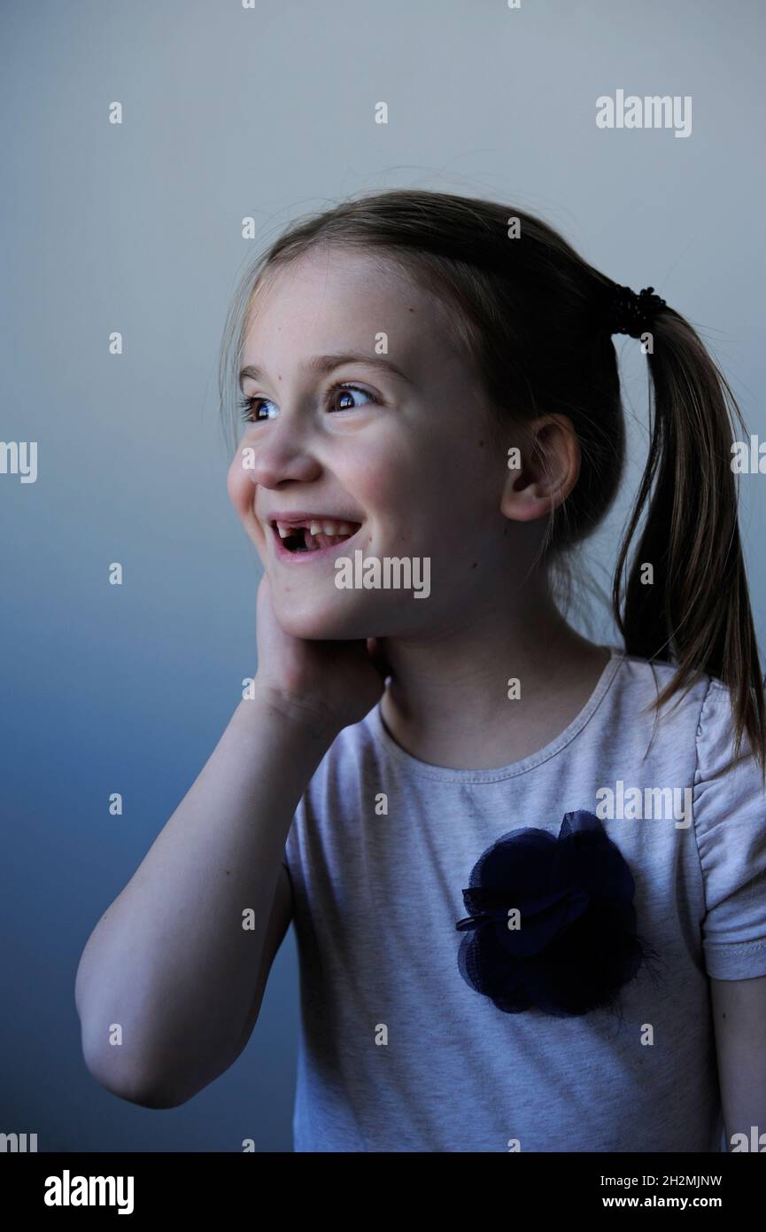 Funny portrait of adorable young girl with two missing teeth in front Stock Photo