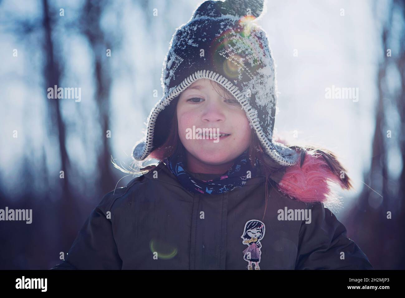 Child playing with snow in winter Stock Photo