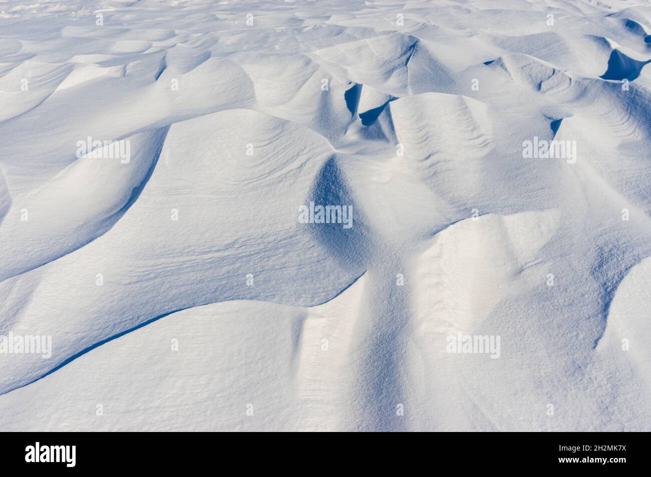 Landscape with snow shapes covering earth when windy weather at winter Stock Photo