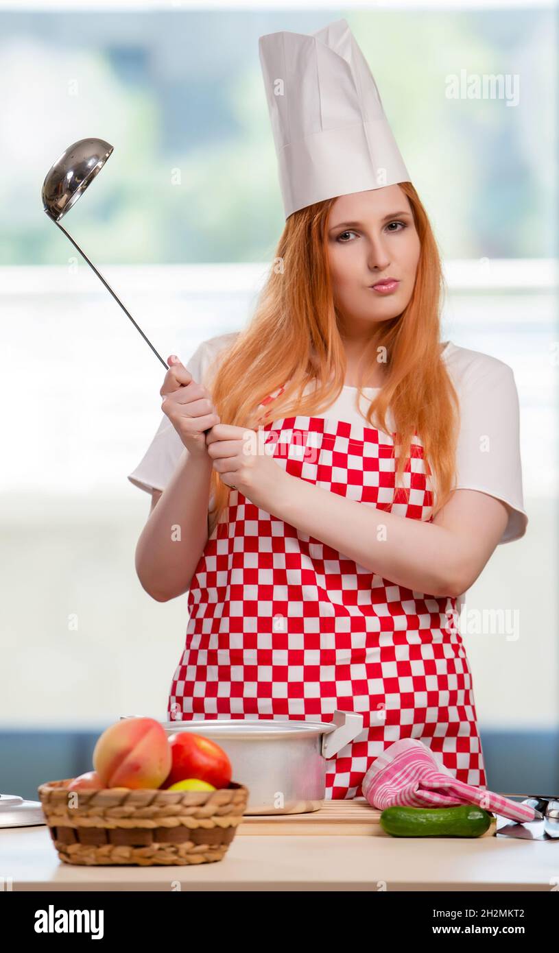 The redhead cook working in the kitchen Stock Photo - Alamy