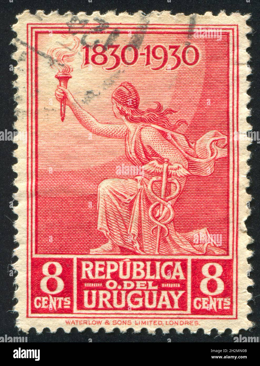 URUGUAY - CIRCA 1930: stamp printed by Uruguay, shows Liberty with Torch and Caduceus, circa 1930 Stock Photo