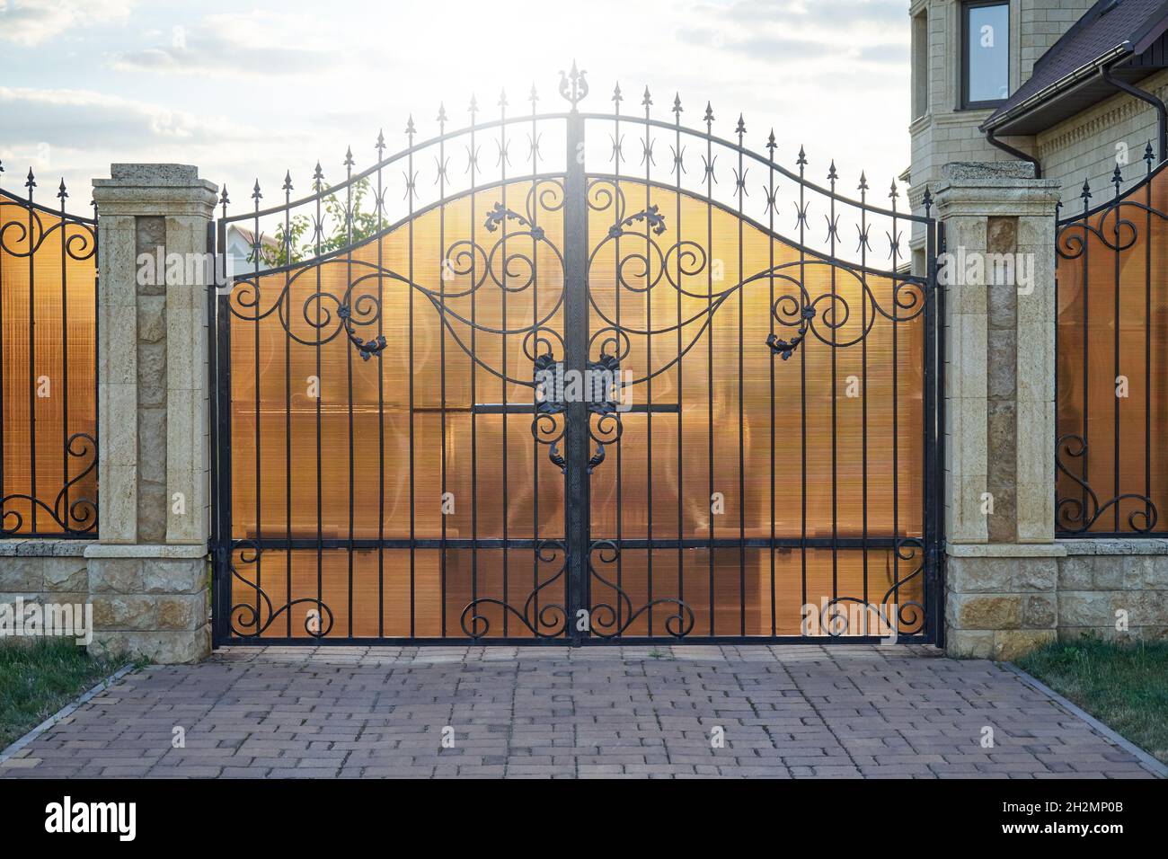Wrought gates with polycarbonate sheet in a private house Stock Photo
