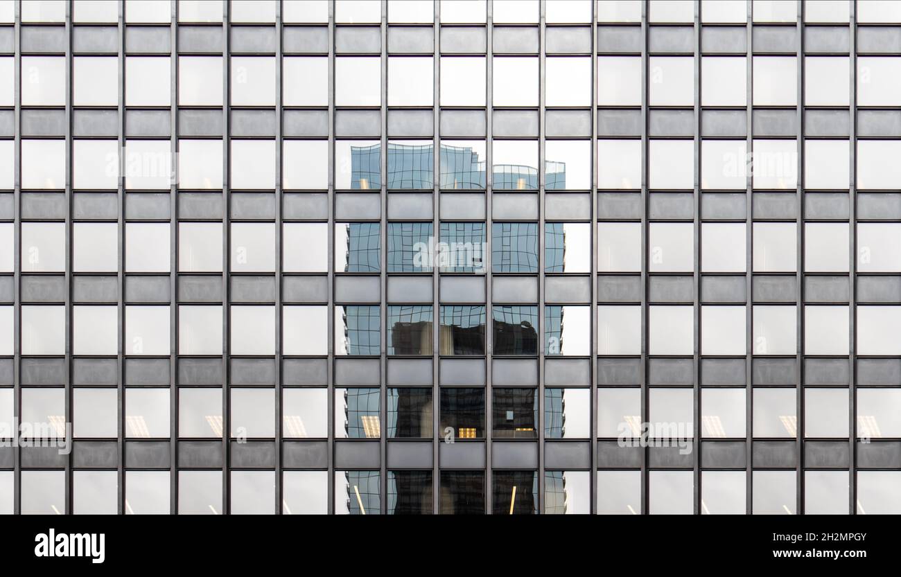 High rise glass building facade. Modern office skyscraper exterior curtain wall background. City business district architecture Stock Photo
