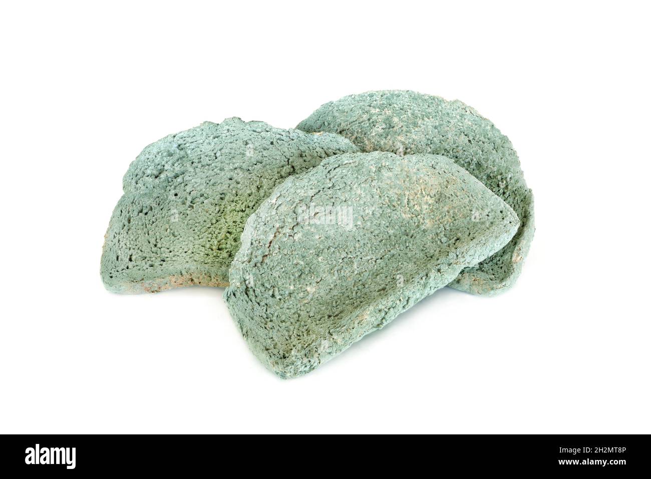 Green mouldy bread slices on white background. Out of use by date usage concept. Stock Photo