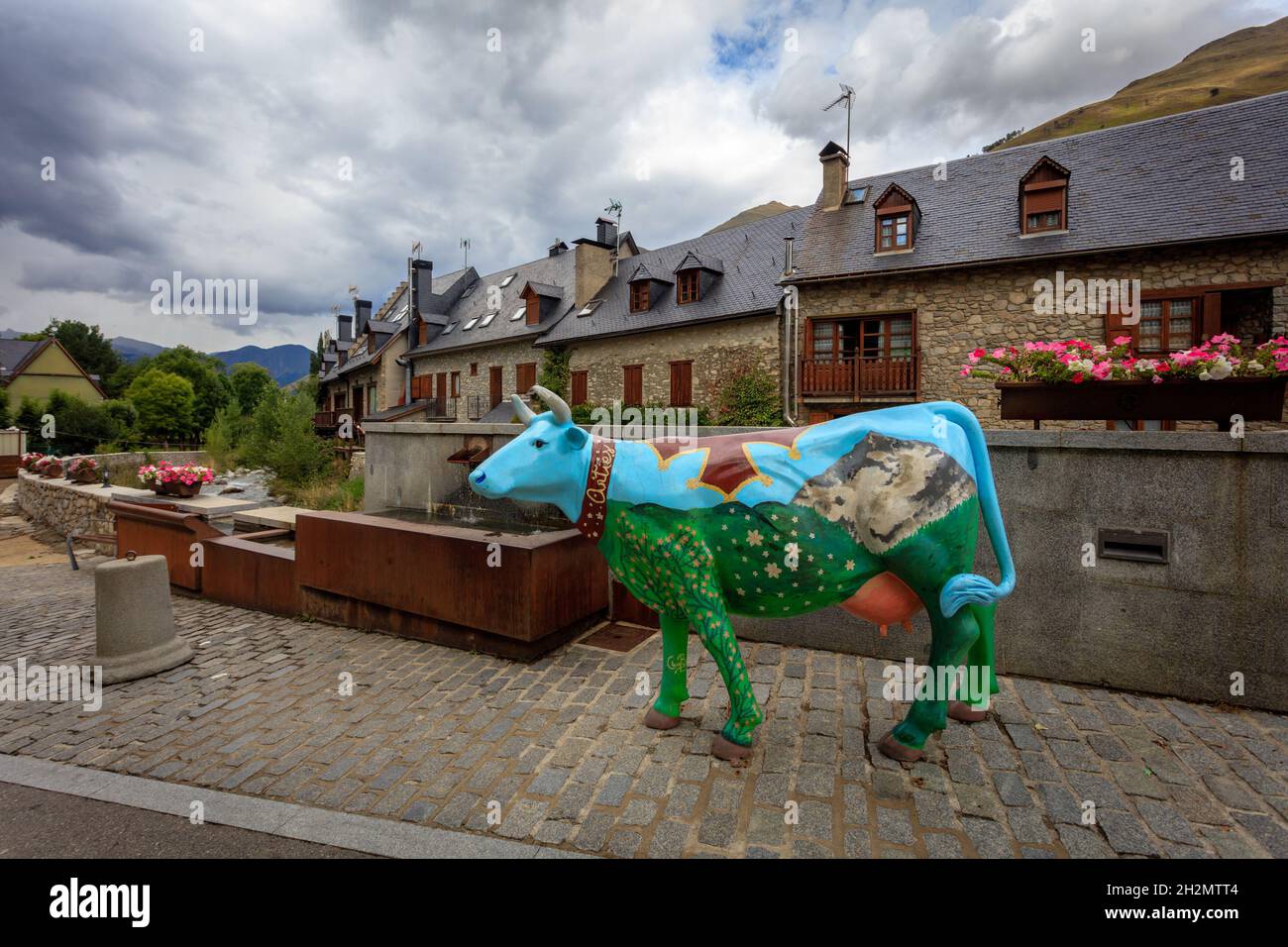 A fiberglass statue of a cow in the streets of Arties, a village in the Aran Valley. Catalonia. Spain. Stock Photo