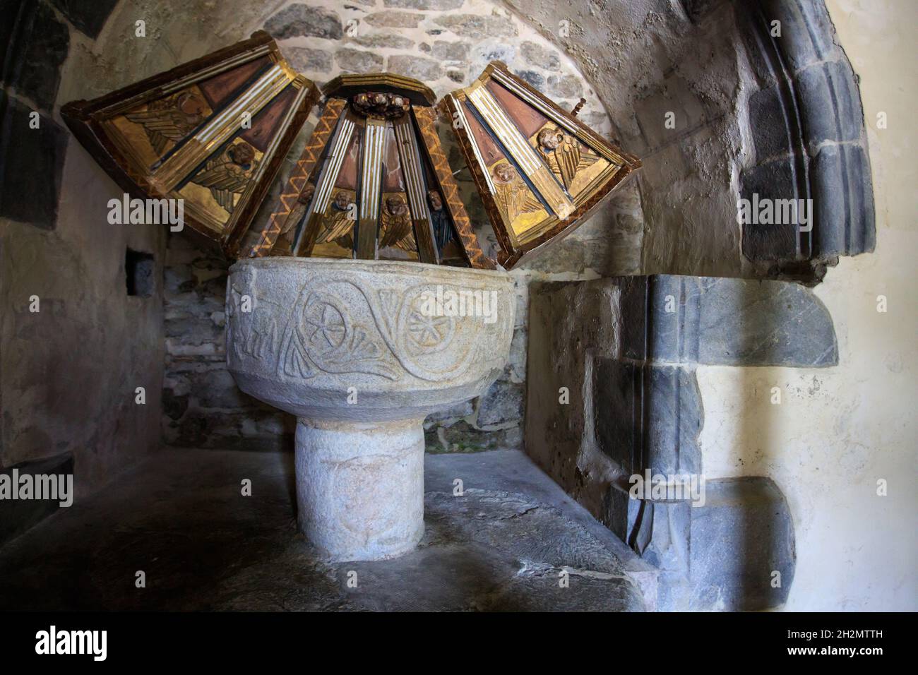 Baptismal font in the romanesque church San Martin de Gausac in the Aran Valley, Catalonia. Spain. Stock Photo