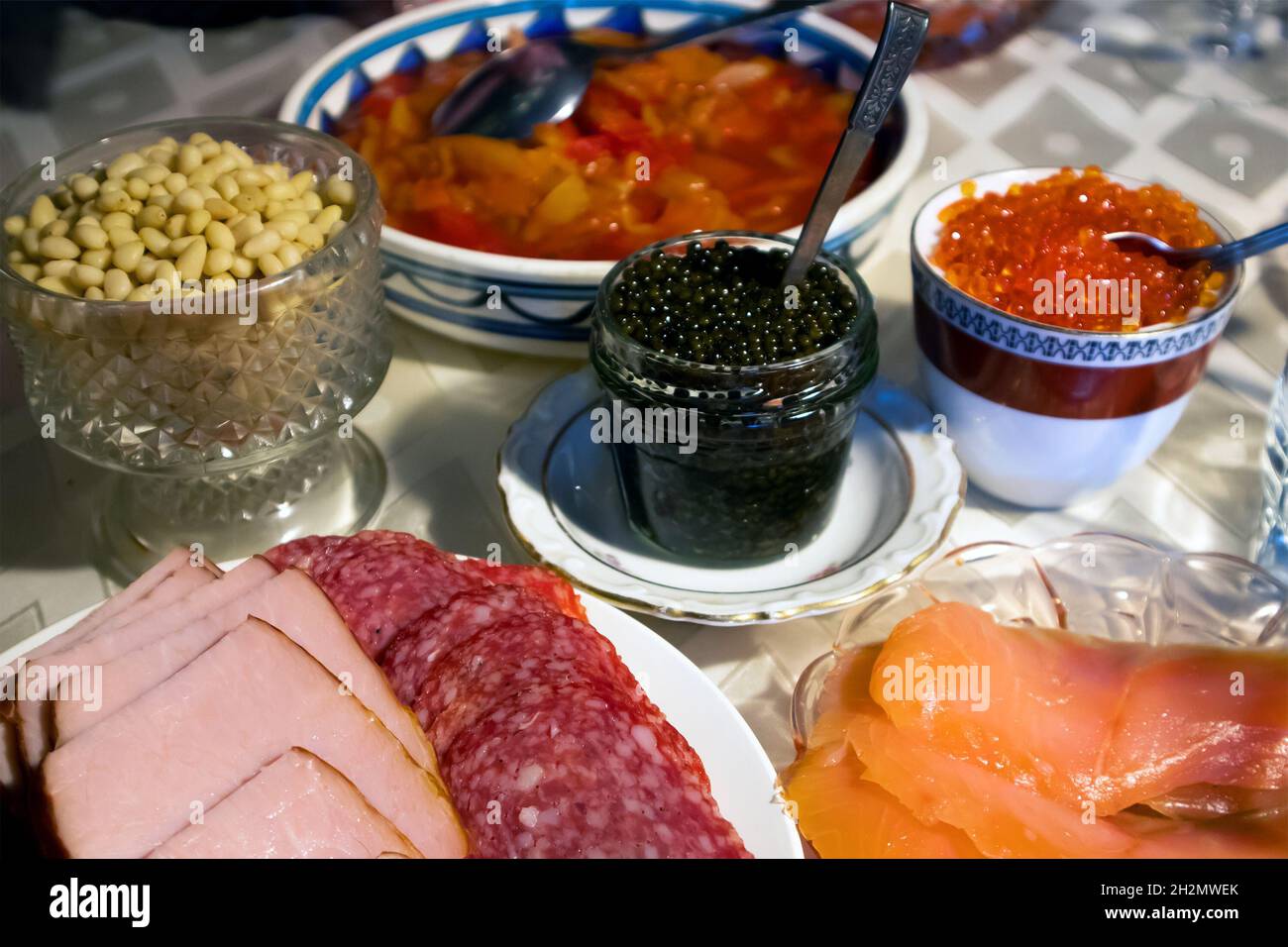 Home festive served table with red and black caviar and other different snacks Stock Photo