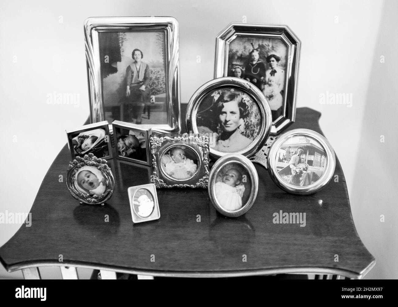 Family memories photographs on display at home Stock Photo