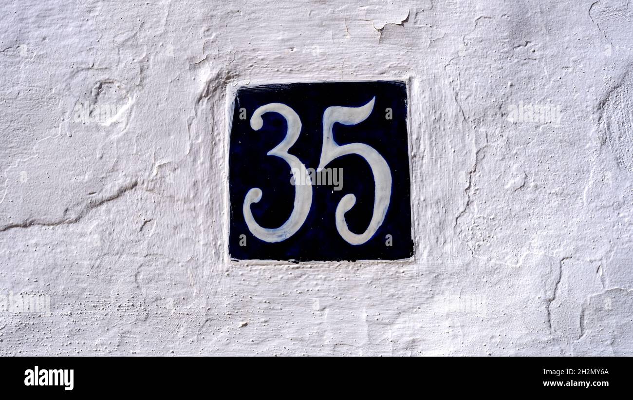 ceramic house number table. number: 35. on a white background Stock Photo