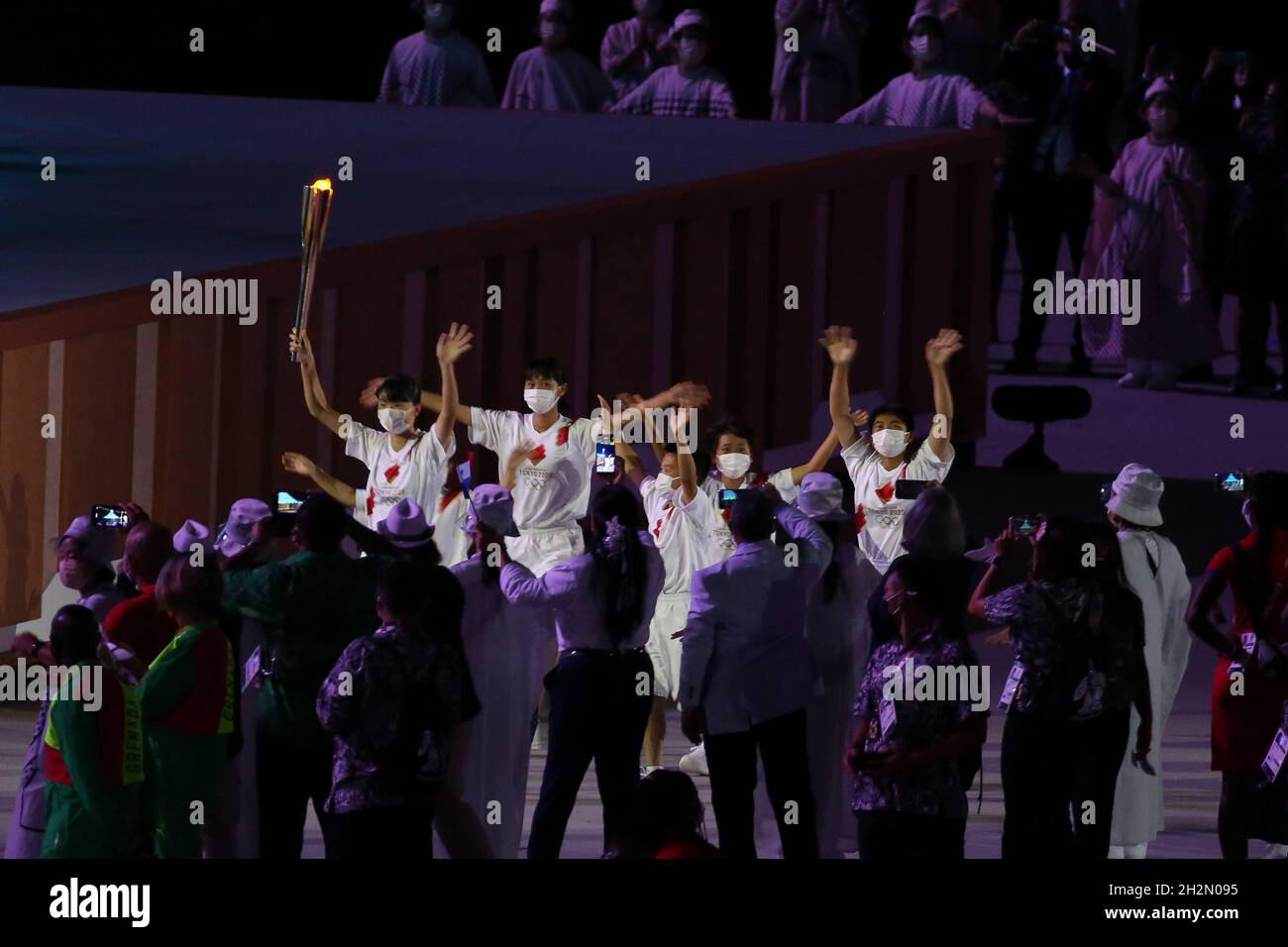 JULY 23rd, 2021 - TOKYO, JAPAN: The olympic flame is carried during the Opening Ceremony of the Tokyo 2020 Olympic Games by AOKI Kokona, NAKAZAWA Ren, Stock Photo