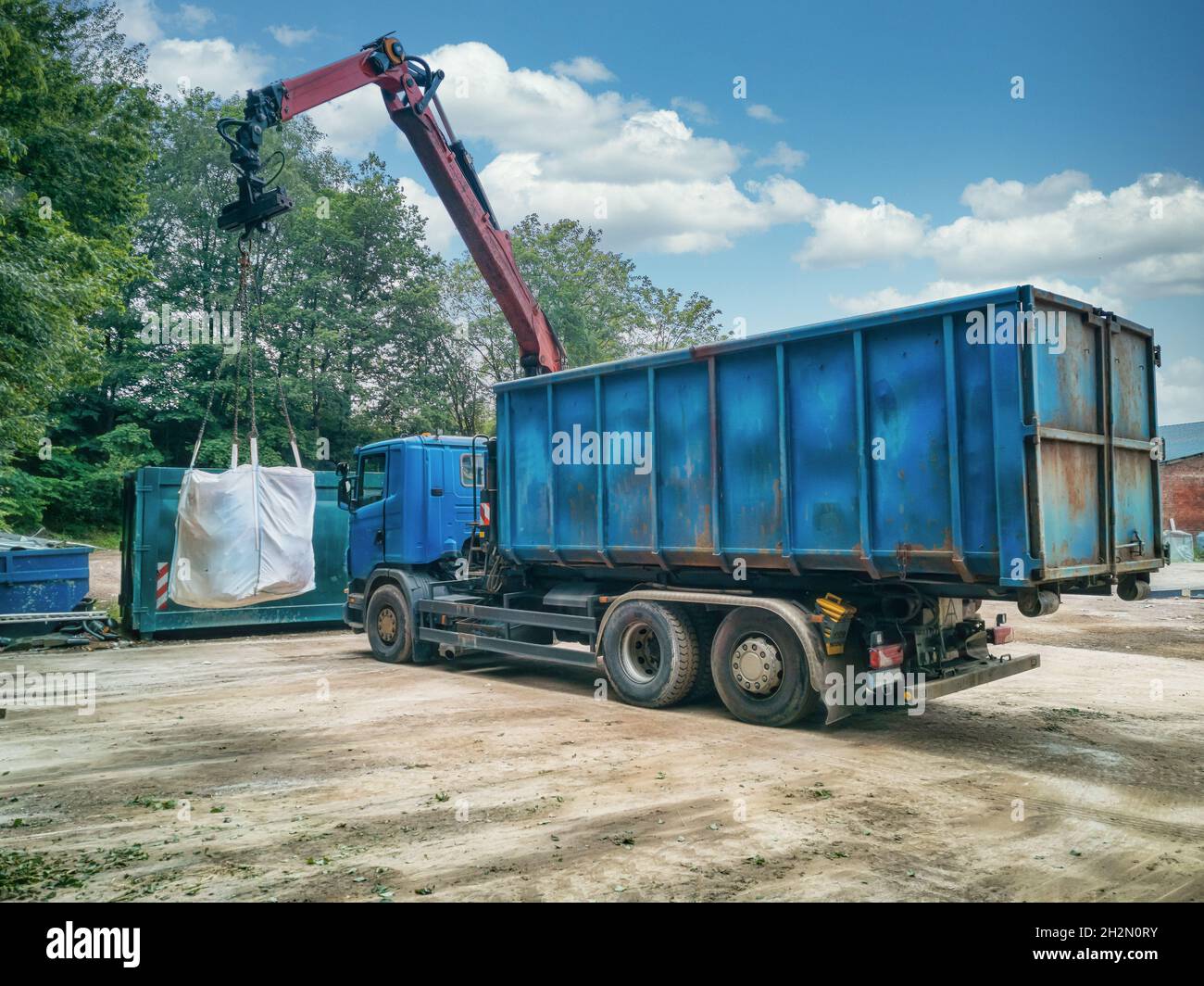 Crane truck with garbage bag on a recycling yard. Stock Photo