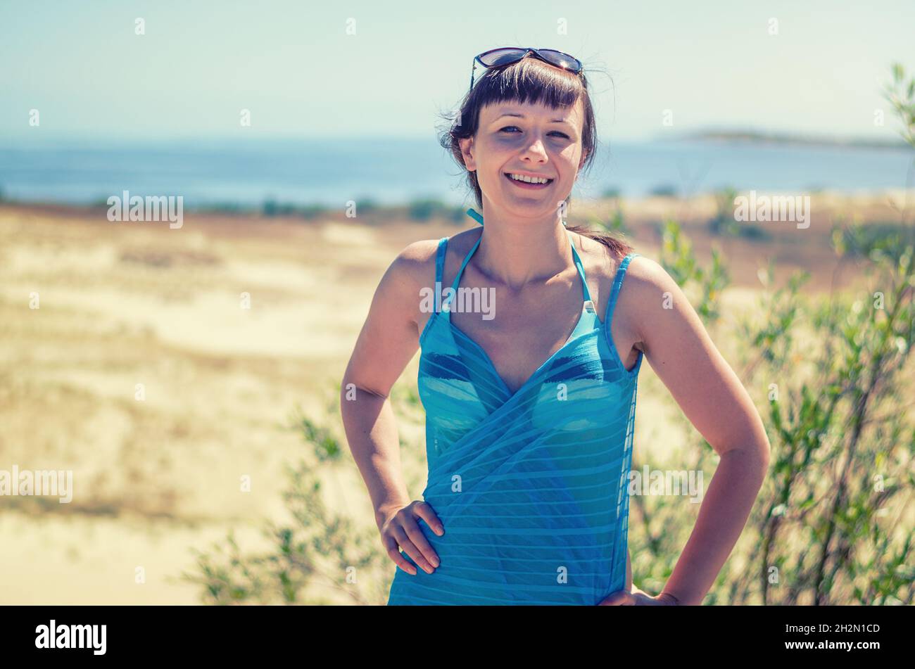 Young beautiful girl in bikini, pareo wrap and sunglasses on head ...