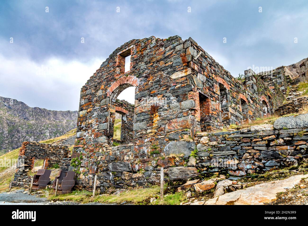 Ruins of the Brittania Copper Mine by Llyn Llydaw lake along the Miners' track up to Mount Snowdon, Snowdonia, Wales, UK Stock Photo