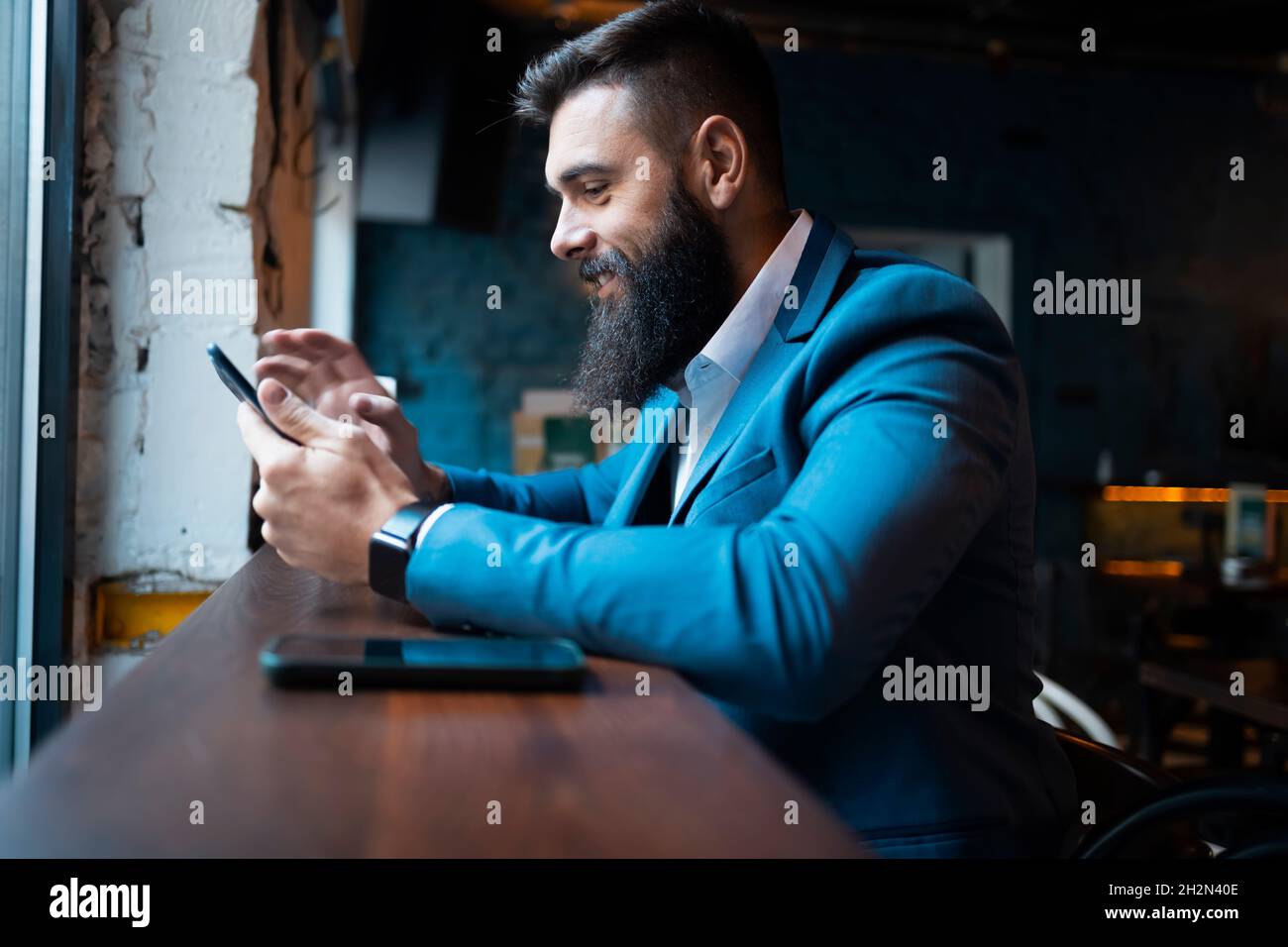 Businessman in a bar buying from the internet Stock Photo
