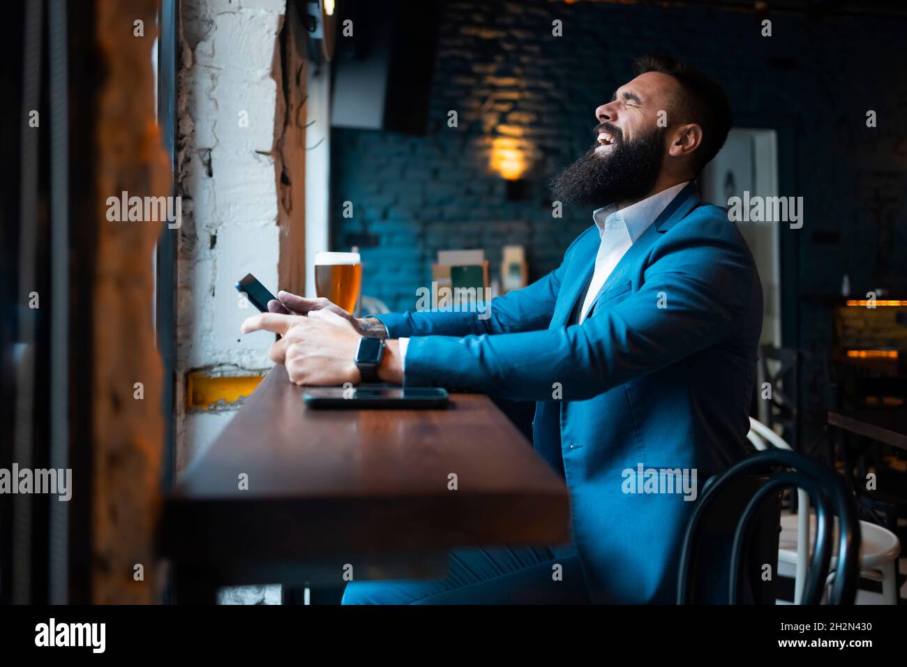 Young businessman smiling in a cafe Stock Photo
